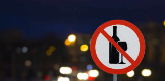 No alcohol sign with blurred city lights