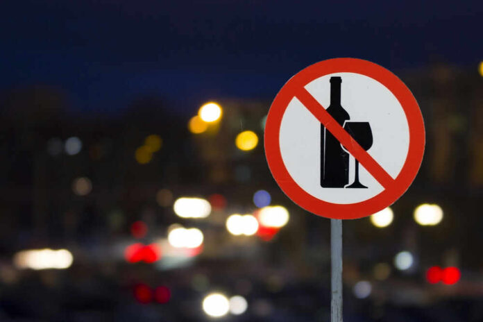 No alcohol sign with blurred city lights