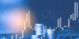 Stacks of coins with financial stock chart overlay.