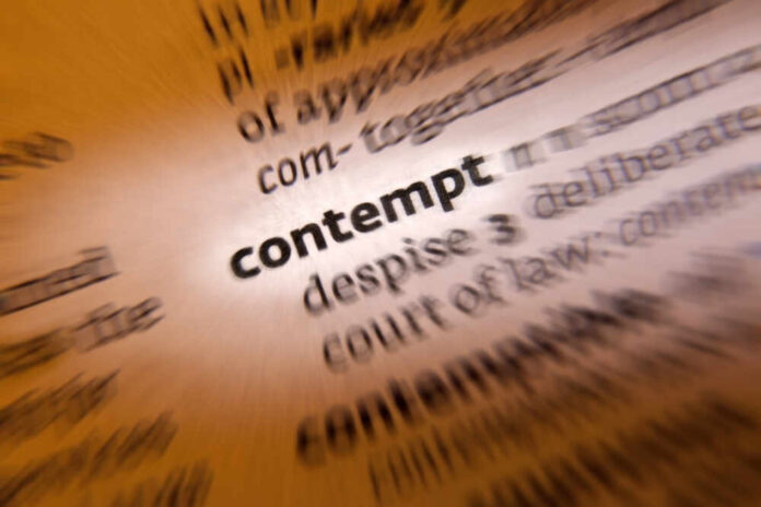Blurred dictionary entry focusing on the word 'contempt'