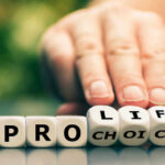 Hand shifting blocks spelling pro life to pro choice