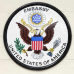 Seal of the United States Embassy featuring an eagle and national colors