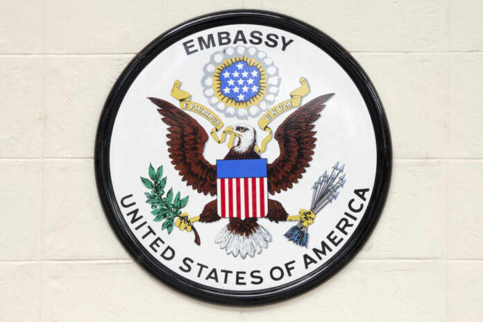 Seal of the United States Embassy featuring an eagle and national colors