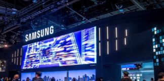 Samsung exhibition booth with a large digital display and attendees