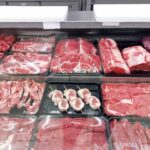 Variety of fresh meats displayed in a butcher shop