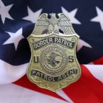 Border Patrol badge resting on an American flag