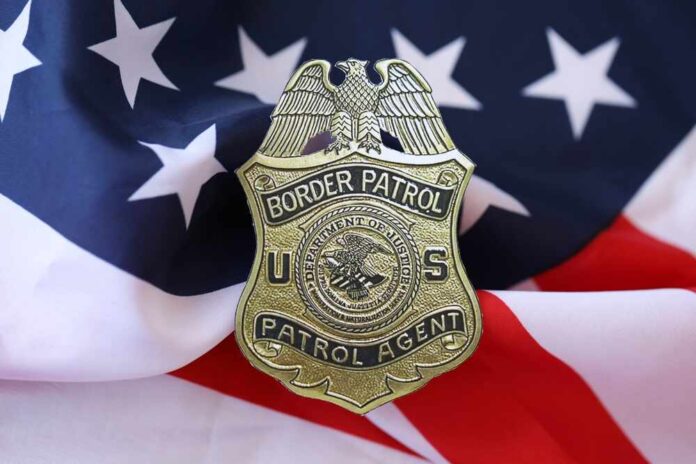 Border Patrol badge resting on an American flag