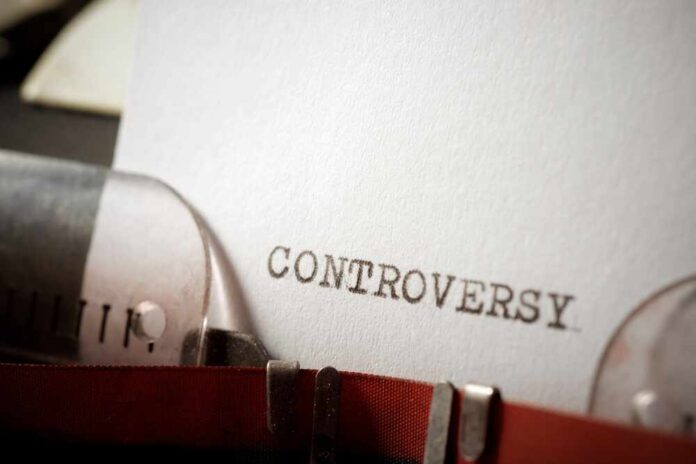 Close-up of a typewriter with the word 'CONTROVERSY' typed on paper