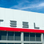 Tesla building with logo against blue sky