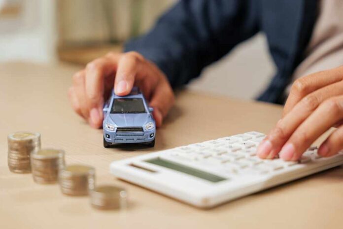 Person calculating expenses with a toy car and coins on the table