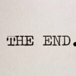Typewritten text reading 'THE END.' on a sheet of paper