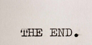 Typewritten text reading 'THE END.' on a sheet of paper