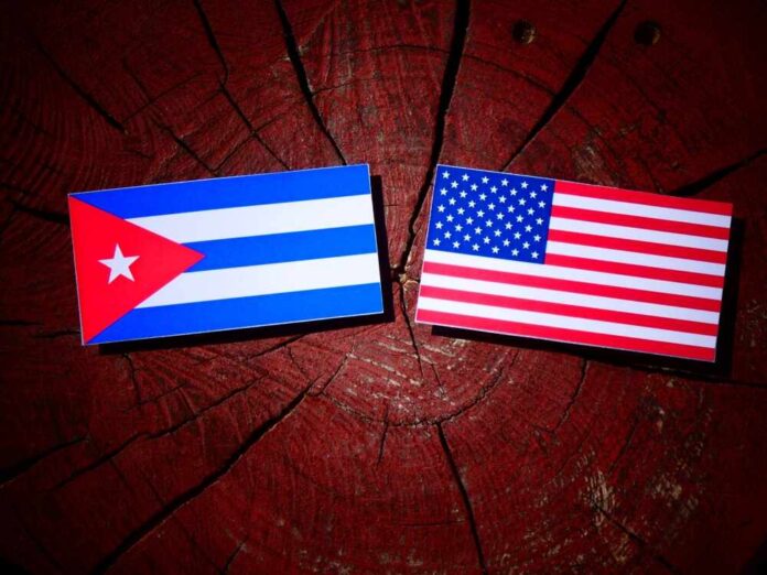 Cuban and American flags placed on a wooden surface