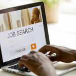 Person searching for jobs on a laptop.