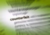 Blurred dictionary entry focusing on the word 'counterfeit'