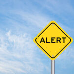 DEVELOPING: Mar-a-Lago Breached — Secret Service Kills Man Yellow alert sign against a blue sky