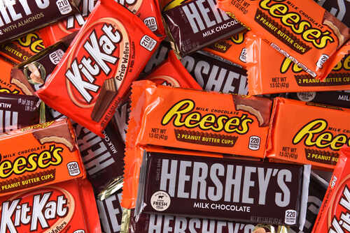 An assortment of chocolate candy bars including Kit Kat, Reese's, and Hershey's