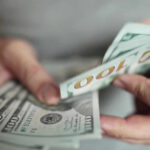 VIDEO: $1 Million Reward — TV Star’s Desperate Plea Hands holding stack of one hundred dollar bills