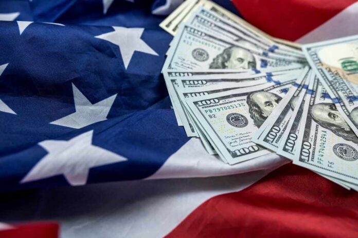 Stack of hundred dollar bills on an American flag