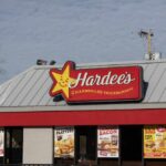 Hardee’s DESTROYS Plant-Based Trend With Real Meat Exterior view of a Hardee's restaurant with signage and promotional posters