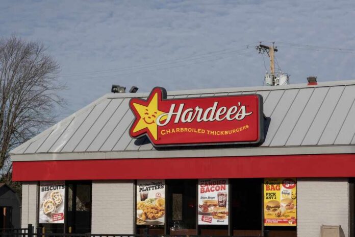 Exterior view of a Hardee's restaurant with signage and promotional posters