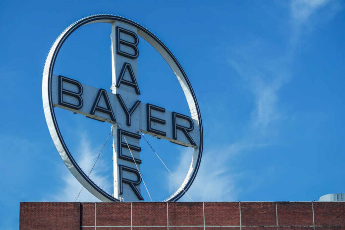 Bayer logo on a building against a clear blue sky