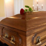 Three Dog Night Icon’s Passing Saddens Fans A wooden casket with a red rose placed on top