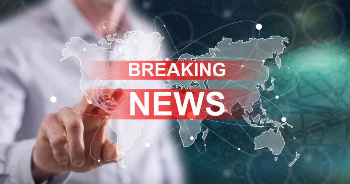 Breaking news graphic over world map background.