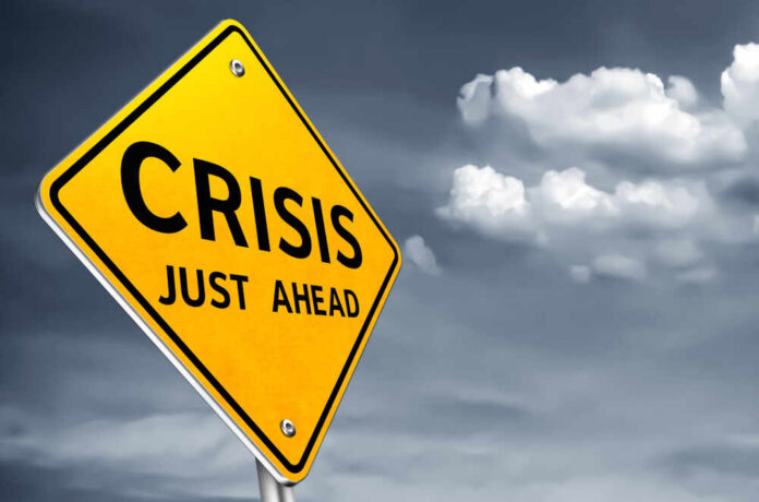 shutterstock_1466766104.jpg A yellow warning sign indicating a crisis ahead