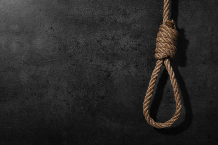 A noose made of rope hanging against a dark textured background