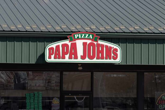 Exterior view of a Papa John's pizza restaurant with a green roof