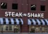 Exterior view of a Steak 'n Shake restaurant with illuminated signage