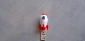 A toy rocket positioned above stacks of cash