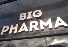 Big Pharma’s BILLION-DOLLAR Experiment Announced Sign displaying the words BIG PHARMA on a glass building
