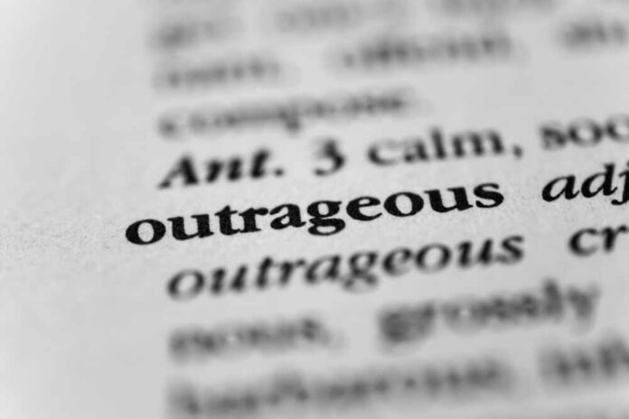 Close-up of a dictionary entry highlighting the word 'outrageous'