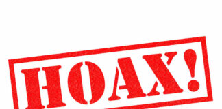 Red stamp with the word 'HOAX' in bold letters