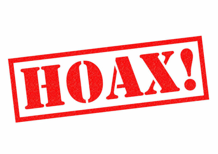 Red stamp with the word 'HOAX' in bold letters