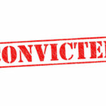 Red stamped text convicted on white background