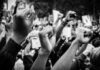 Raised fists at a protest rally, black and white image.