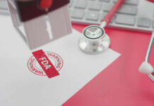 FDA warning stamp near stethoscope and keyboard
