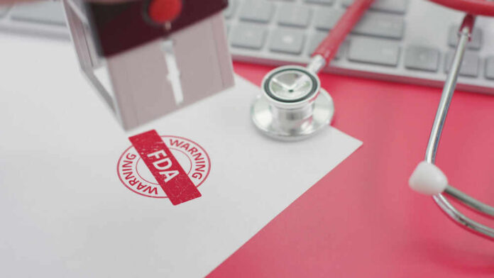 FDA warning stamp near stethoscope and keyboard