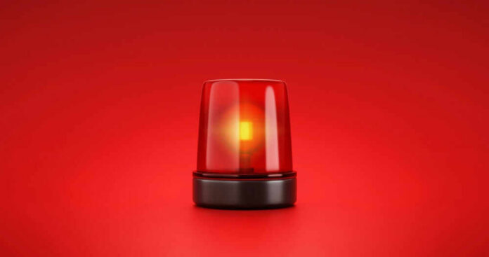 shutterstock_2053758056.jpg Red emergency light on red background