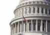 U.S. Capitol dome with American flag flying.