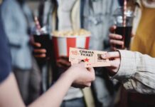 $629M Blockbuster Defies Hollywood Experts Hands exchanging a cinema ticket with popcorn in the background