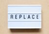 Lightbox sign displaying the word 'REPLACE'