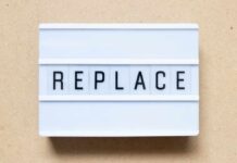 Lightbox sign displaying the word 'REPLACE'