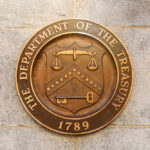 Department of the Treasury seal on stone wall