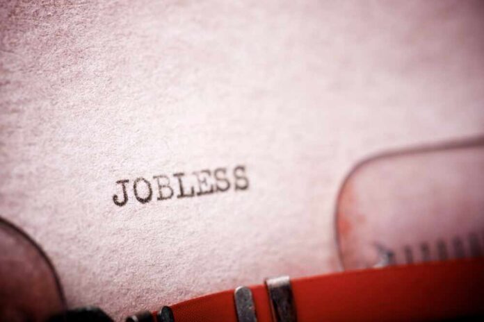 Close-up of a typewriter with the word 'JOBLESS' typed on paper