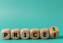 Wooden blocks spelling 'PRICE' with arrows indicating increase and decrease