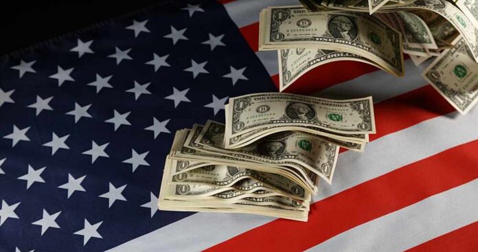 Dollar bills arranged on an American flag
